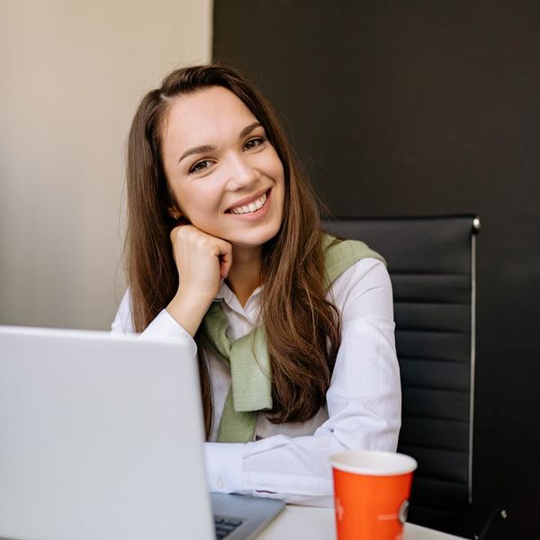 Woman feeling energetic and balanced in a bright, modern space.